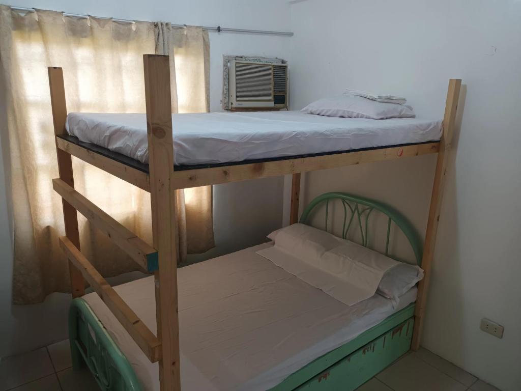 a couple of bunk beds in a room at Two-Hearts Dormitory in Dagupan