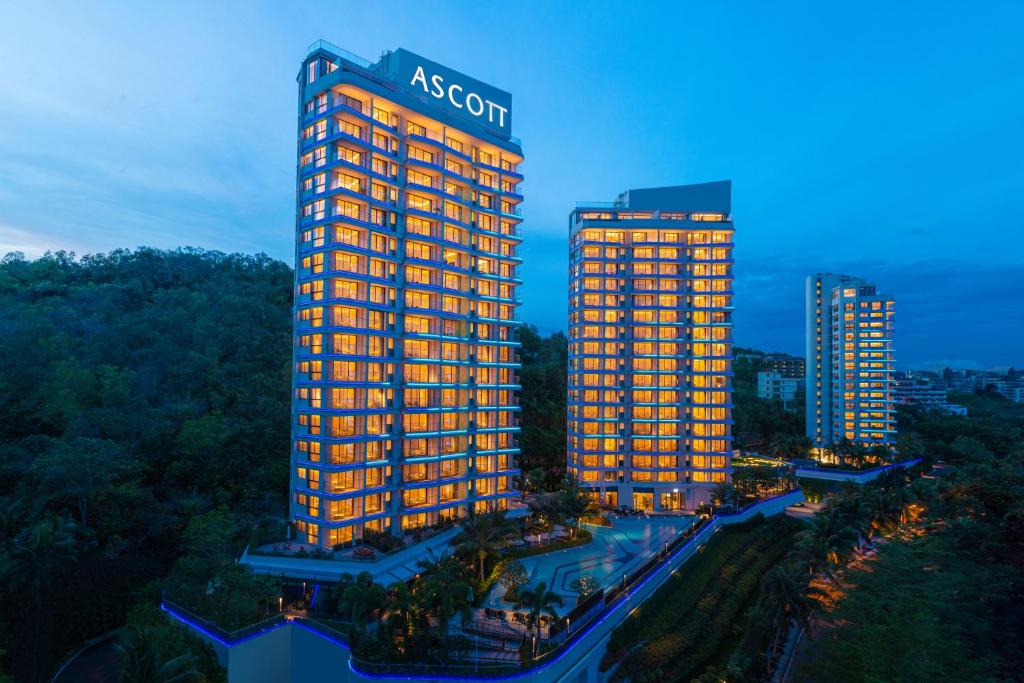 an illuminated building with a acorn sign on top of it at Ascott Dadonghai Bay Sanya in Sanya