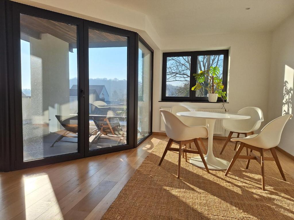 a living room with a table and chairs at Brussels countryside in Hoeilaart