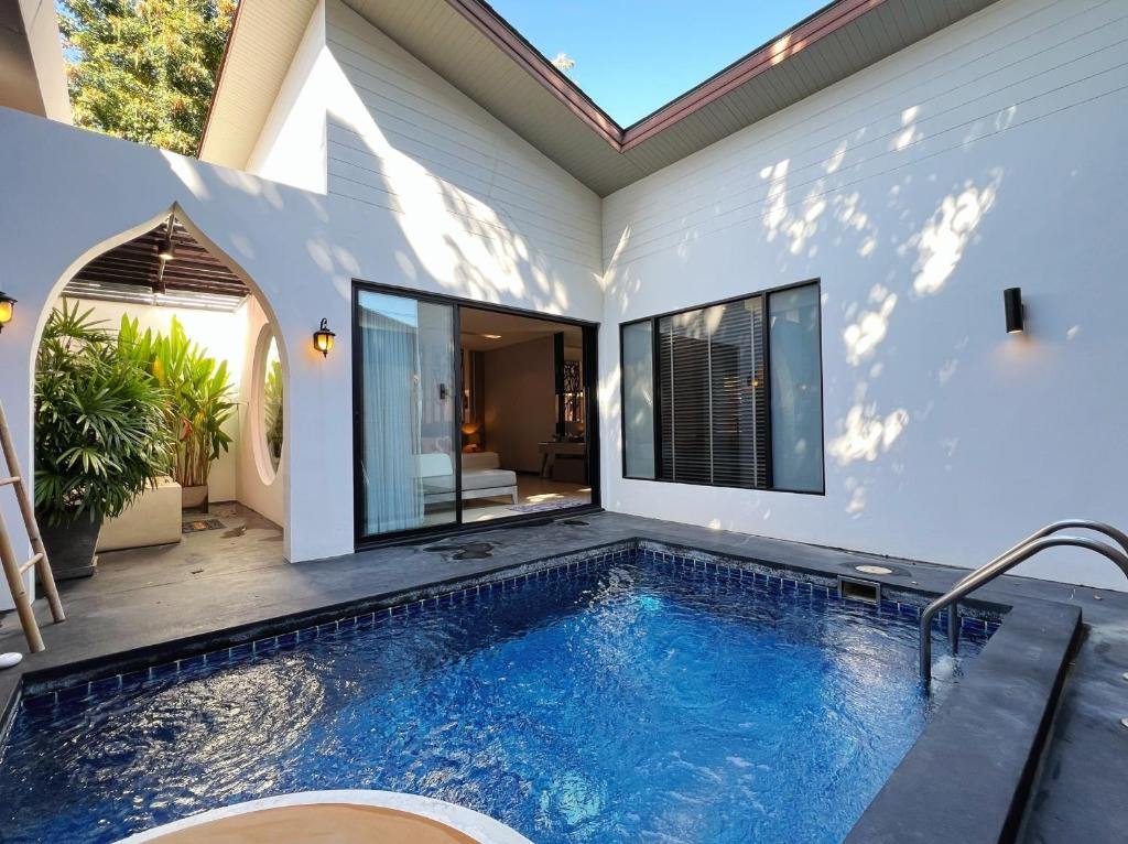 a swimming pool in the backyard of a house at Cae Villa Hua Hin in Hua Hin