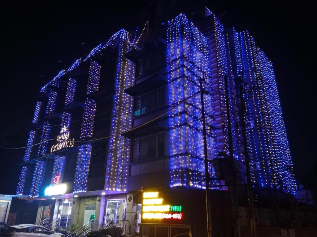 a building covered in blue christmas lights at night at HOTEL COSMOS in Bijnaur