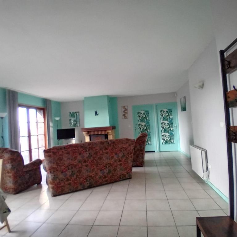 a living room with a couch and a table at LA VALLEE MARIAUX in Bossus-lès-Rumigny