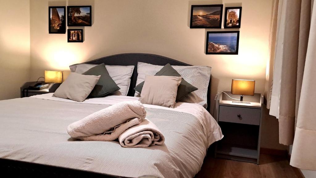 a bedroom with a bed with white sheets and pillows at Hotel Del Viale in Agrigento