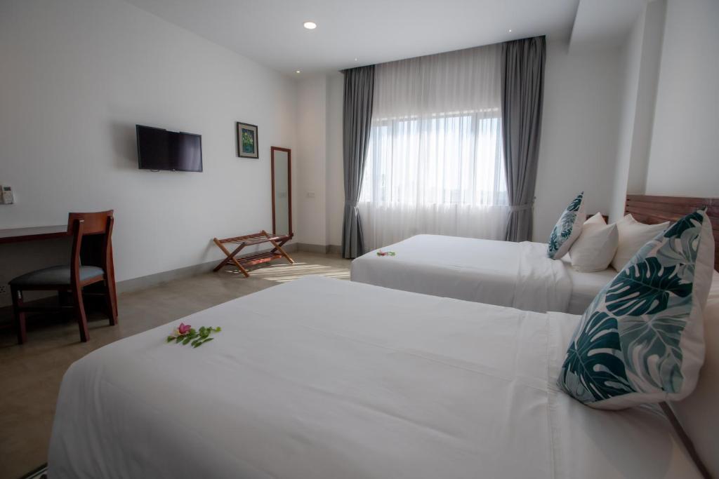 Postel nebo postele na pokoji v ubytování DACO Hotel