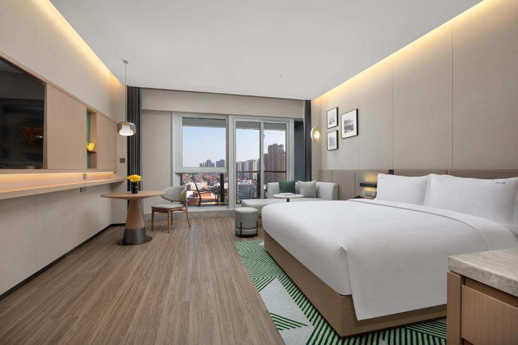 Postel nebo postele na pokoji v ubytování Holiday Inn Quanzhou Donghai by IHG