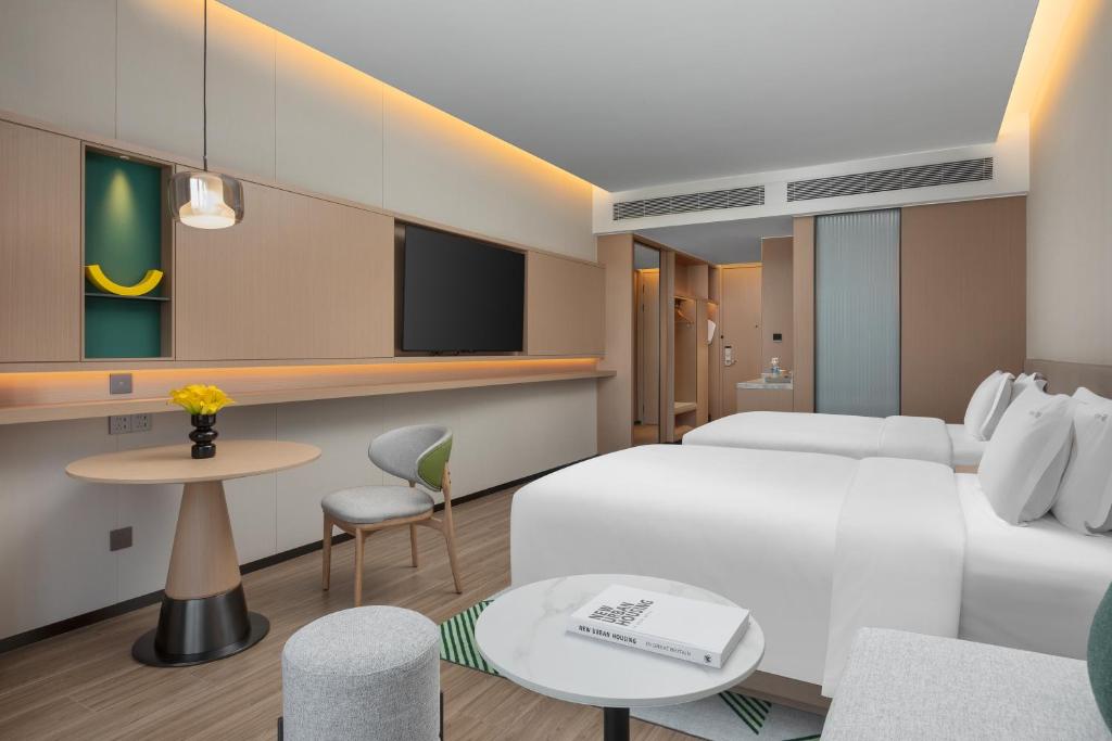Postel nebo postele na pokoji v ubytování Holiday Inn Quanzhou Donghai by IHG