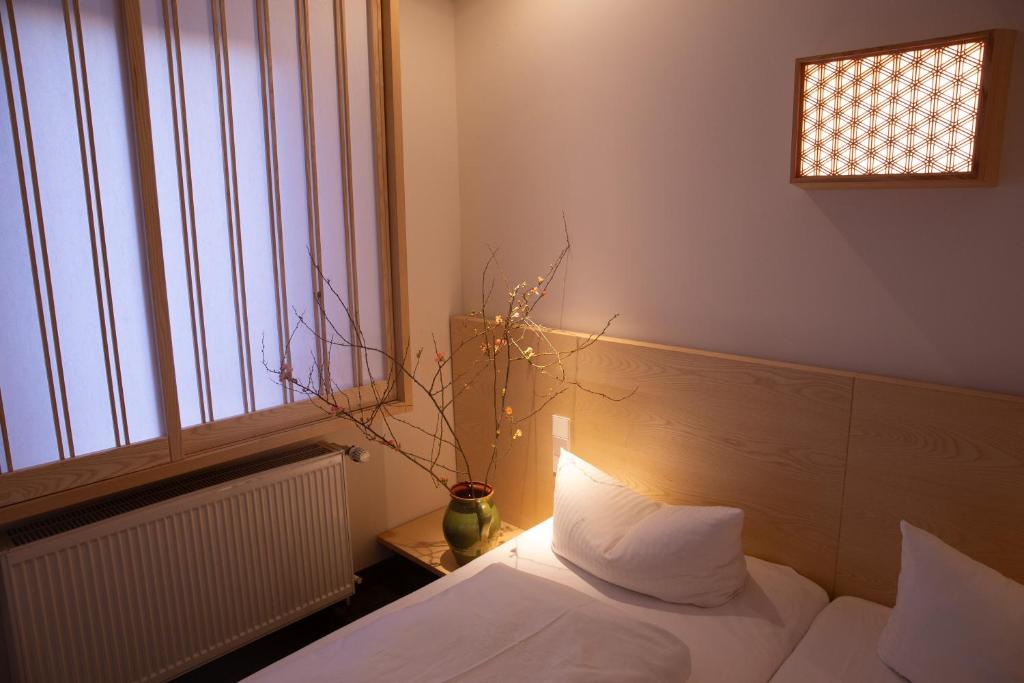 Schlafzimmer mit einem Bett und einem Fenster in der Unterkunft Hotel de Saxe Leipzig in Leipzig