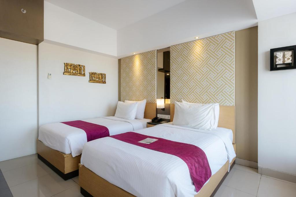 Postel nebo postele na pokoji v ubytování Horison Ultima Seminyak Bali - CHSE Certified