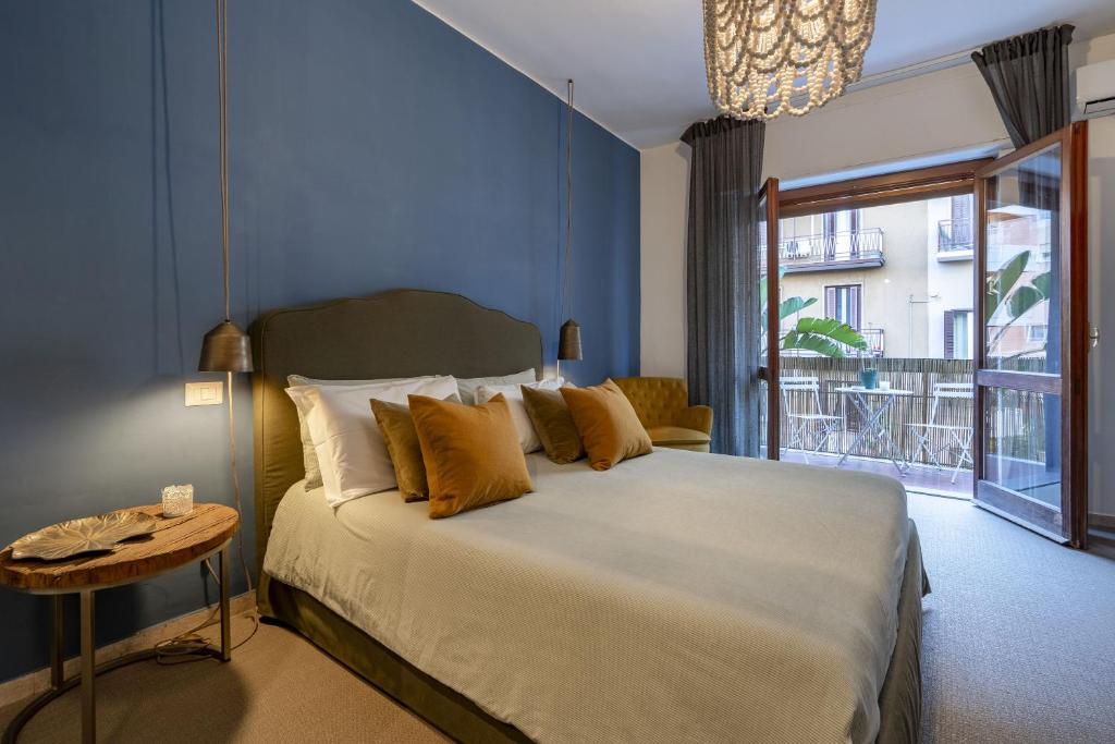 a bedroom with a large bed and a large window at House Putignani 181 in Bari