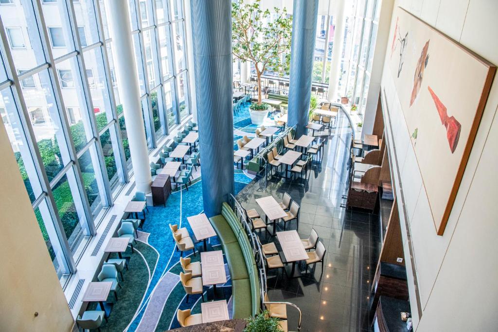 a view of the lobby of a building with tables and chairs at Shibuya Excel Hotel Tokyu in Tokyo