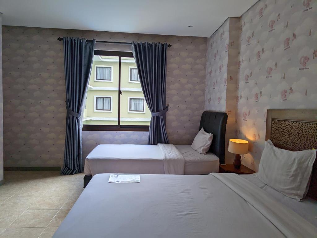Postel nebo postele na pokoji v ubytování Hotel Nalendra Plaza Subang