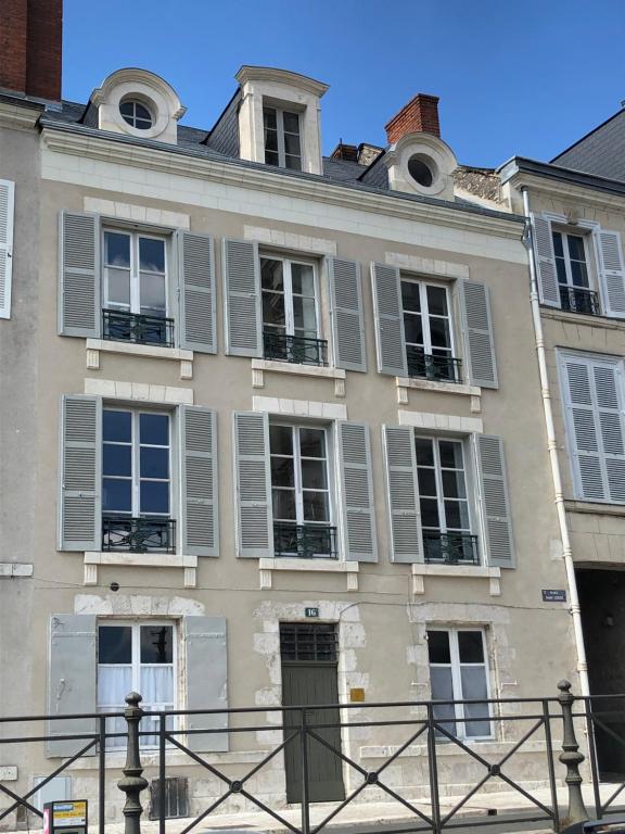 an old building with gray shutters on it at Au 16 Place Saint Louis in Blois