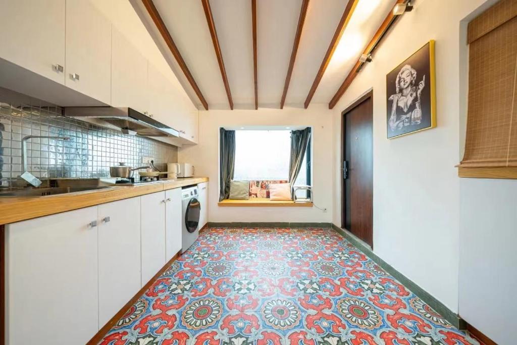 a large kitchen with a tile floor and a door at Shanghai Hills & Serendipity Roof House in Shanghai