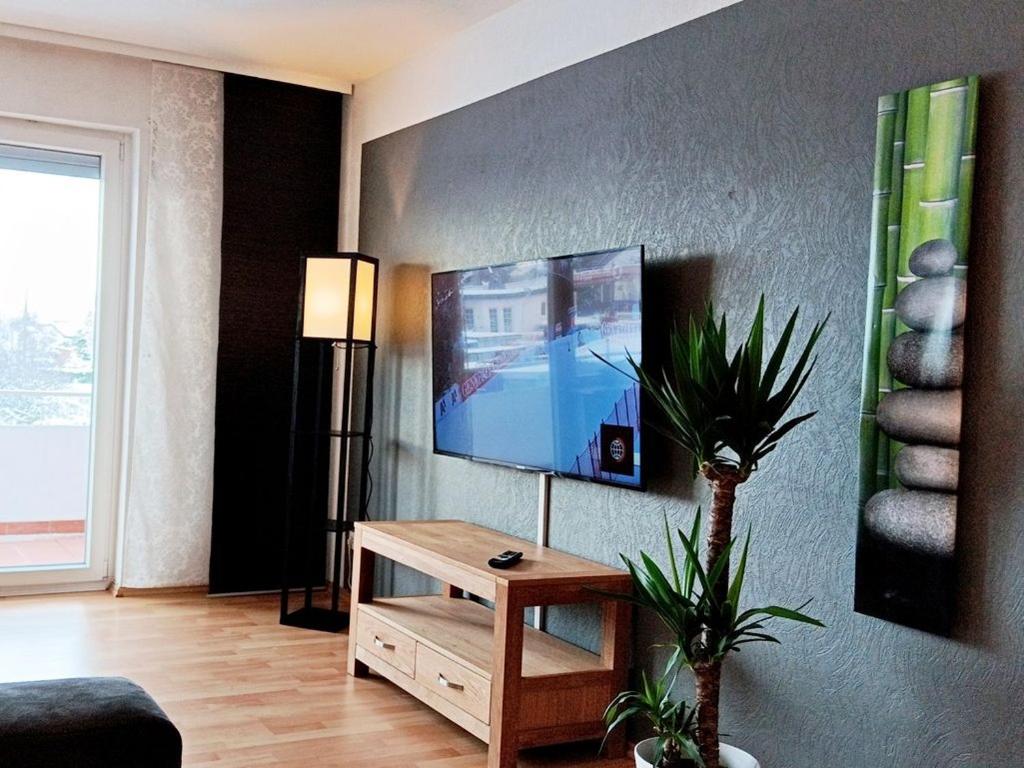 a living room with a flat screen tv on a wall at Abendsonne Obergeschoss mit Balkon in Koblenz