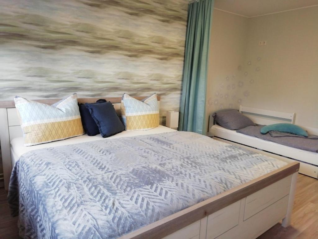 Schlafzimmer mit einem Bett mit Wandgemälde in der Unterkunft Am Froschteich in Dolgen