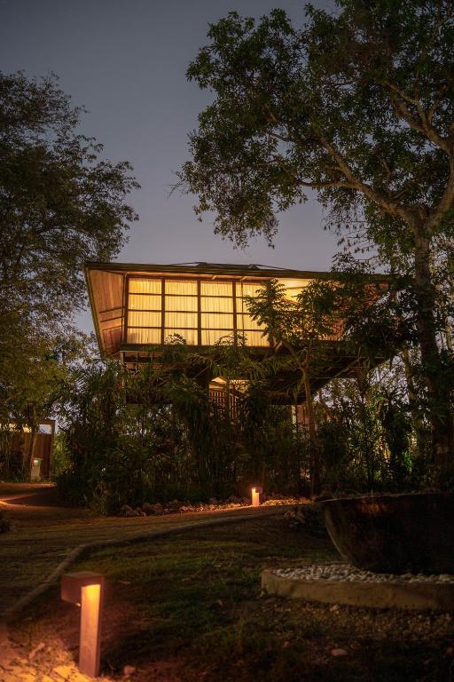 a building with a lot of windows in a park at Grün Resort Uluwatu in Uluwatu