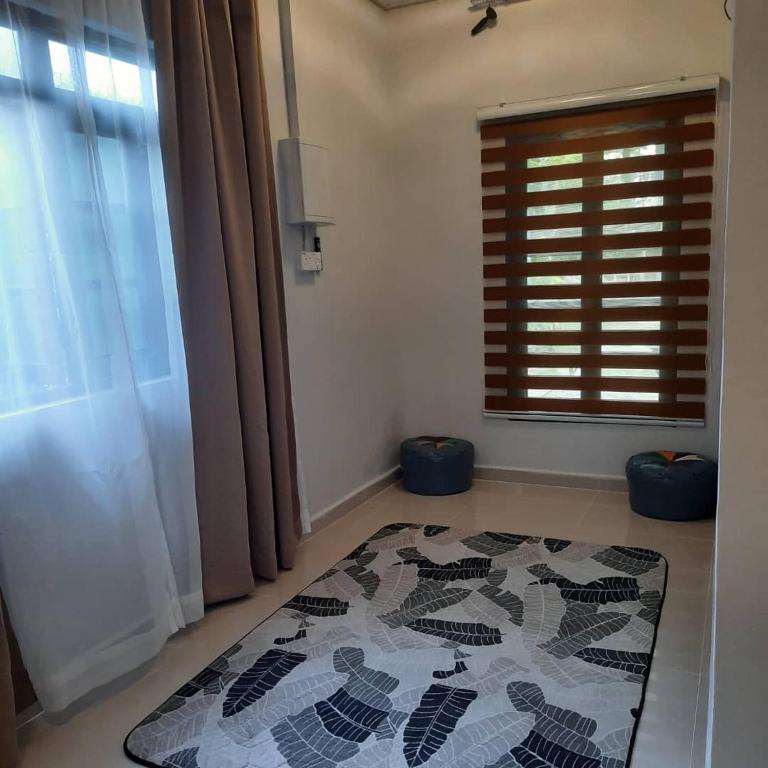 a room with a rug on the floor with a window at Hidden Homestay in Marang