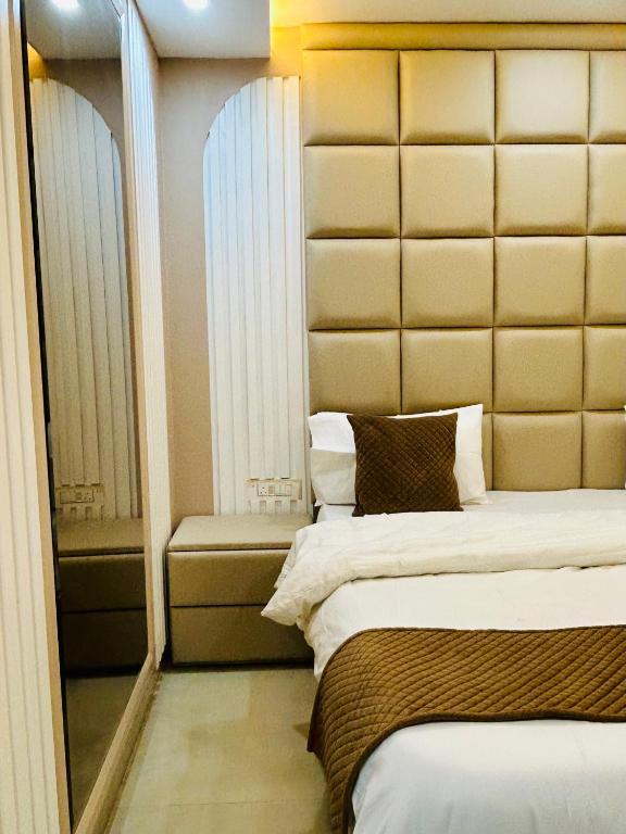 a bedroom with a bed with a large headboard at The Cozy Cool Cabin in Dehradun
