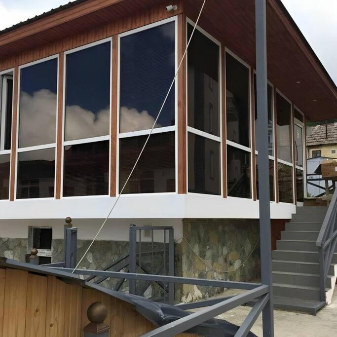 a building with large windows on the side of it at Glass House Bakuriani in Bakuriani