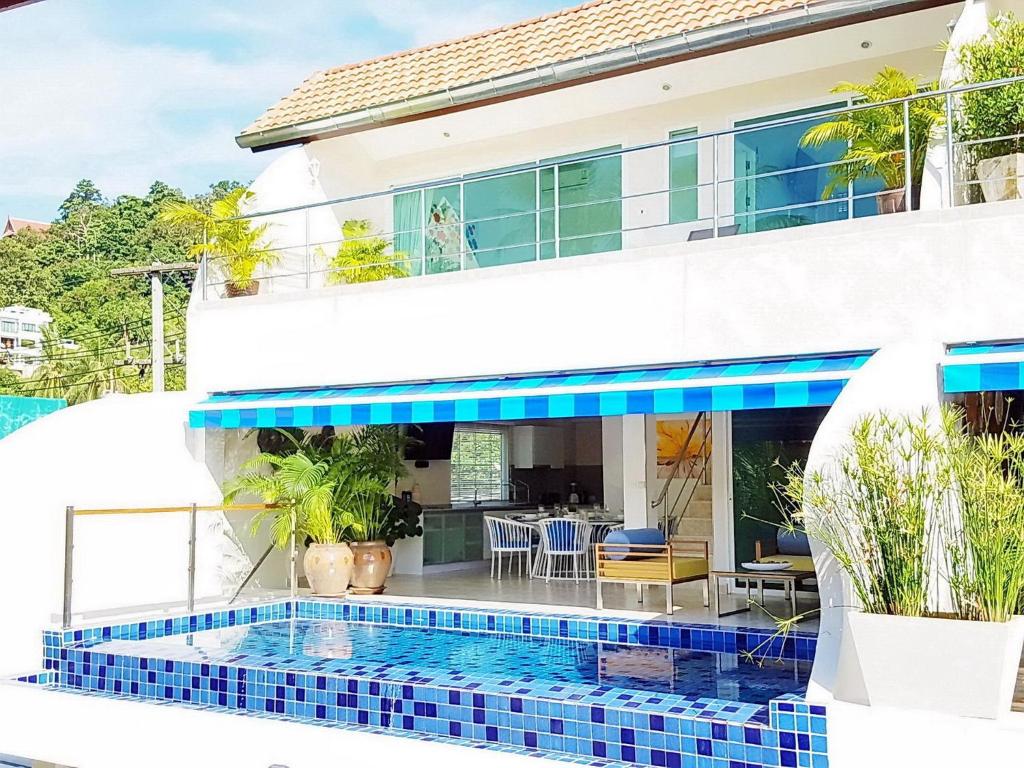 a house with a swimming pool in front of a house at Cosy 3 Bedroom Duplex w/ Private Pool Near Beach! in Mae Nam