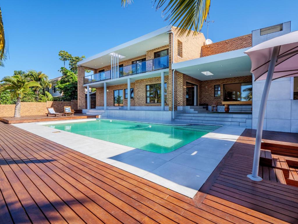 a house with a swimming pool on a wooden deck at One on Chelsea in Durban