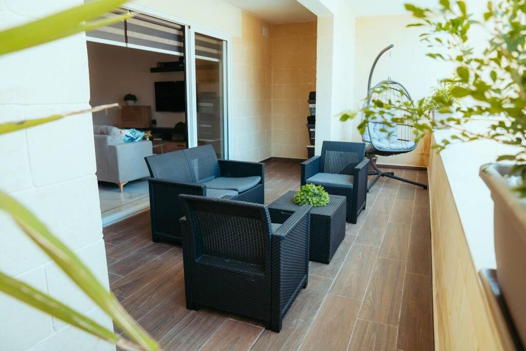 a living room with two chairs and a table at Luxurious Gozo Apartment, Qala in Qala