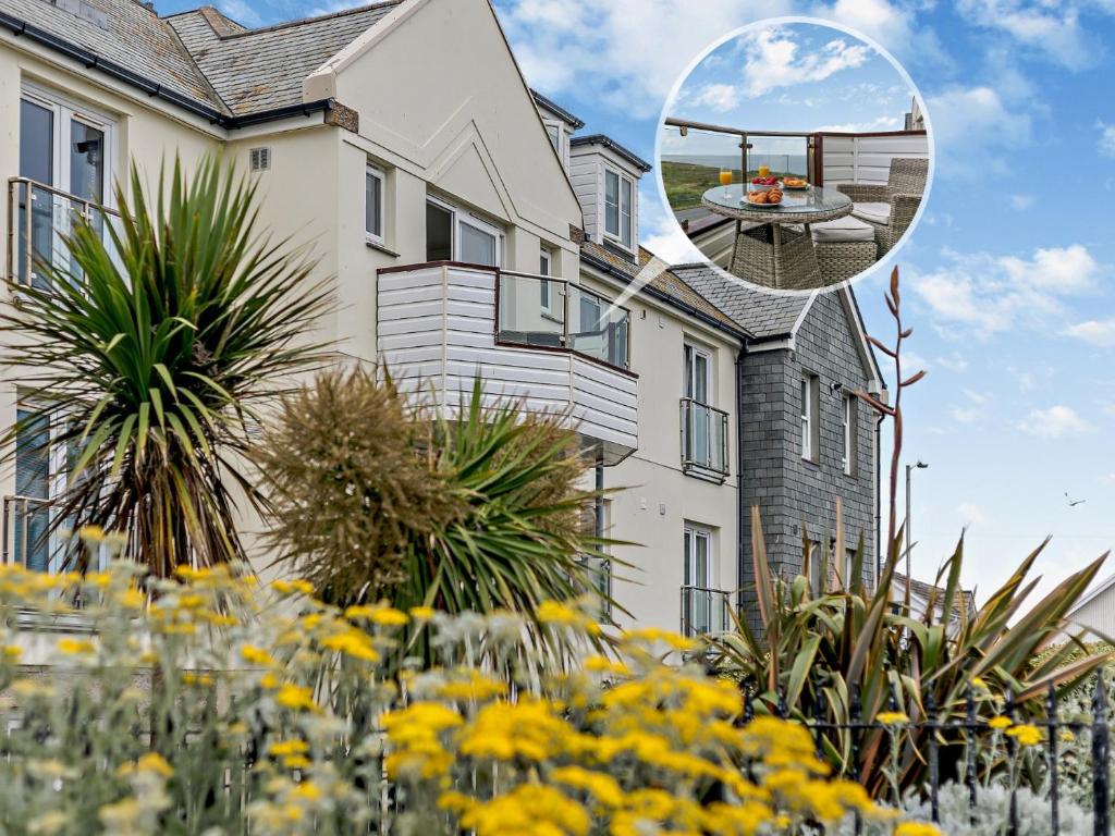 a house with a garden with yellow flowers at 3 Bed in Newquay SPINS in Newquay