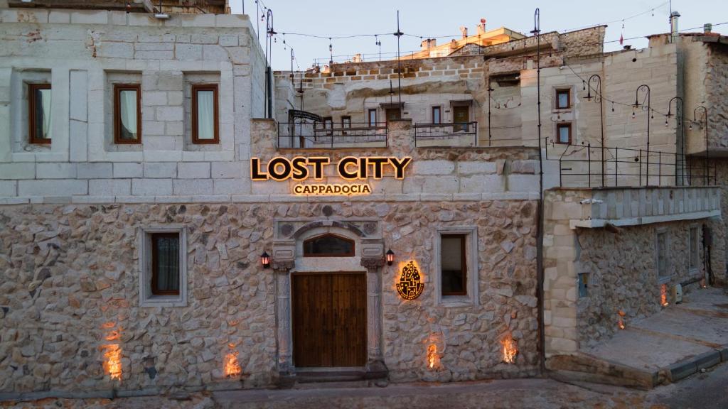 a building with a lost city sign on it at Lost City Cappadocia Cave Hotel in Nar