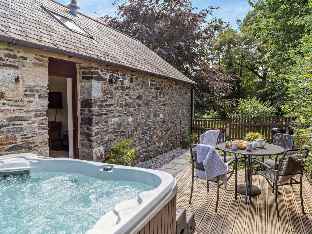 a hot tub on a deck next to a table at 2 Bed in Callington TYLER in North Hill