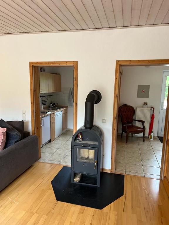 a living room with a wood stove in a room at Schicke Ferienwohnung im Wendland 