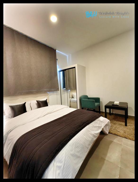 Postel nebo postele na pokoji v ubytování Weibdeh Heights Hotel Suites