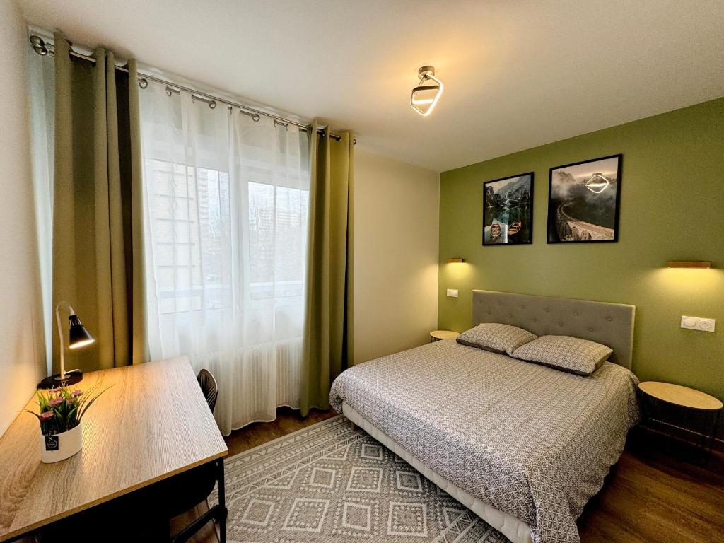 Schlafzimmer mit einem Bett, einem Schreibtisch und einem Fenster in der Unterkunft T2 Tête d’Or Confort + Parking gratuit in Villeurbanne