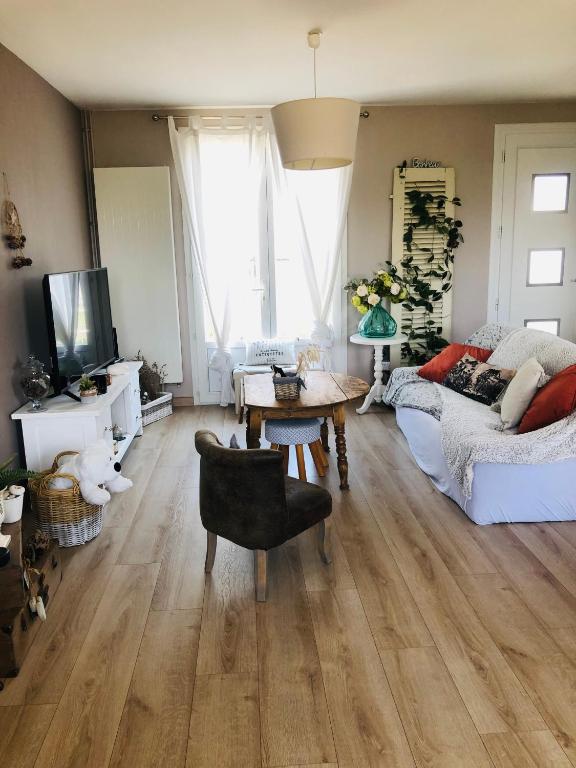 un salon avec un lit et une table dans l'établissement Maison paisible, à Niort