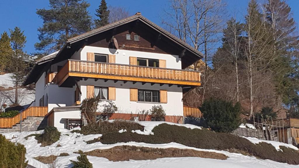 a house with a balcony in the snow at Apartment Sonnenbüchel in Wald am Arlberg