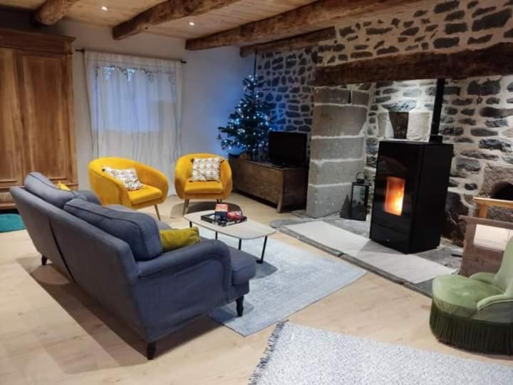 a living room with a couch and a fireplace at Gîte du Milan royal in Le Monteil