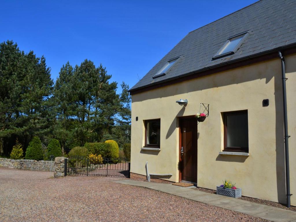 a small white building with a brown door at 2 Bed in Bamburgh 36338 in East Ord