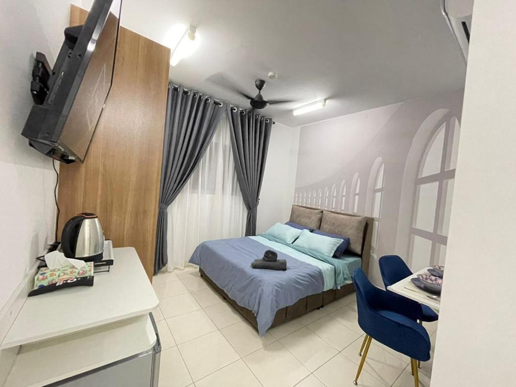 a bedroom with a bed and a table and chairs at Lenore & Myna Suite at Alanis Residence Sepang, KLIA Homestay Apartment in Sepang