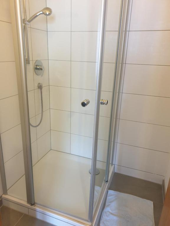 a shower with a glass door in a bathroom at Shalom 