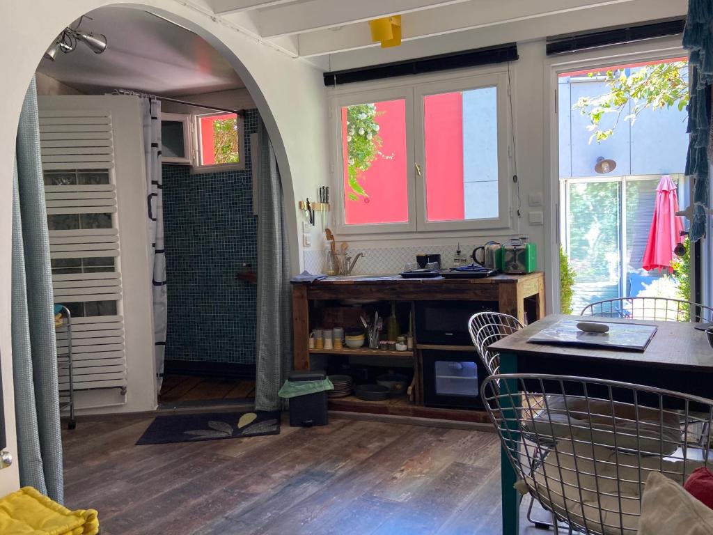 a kitchen with a sink and a shower in a room at charmante maisonnette in Le Havre