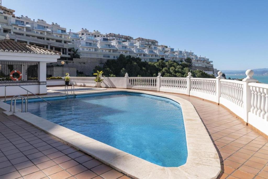a swimming pool on the balcony of a building at Estupendo Apartamento Mediterráneo in Faro de Cullera