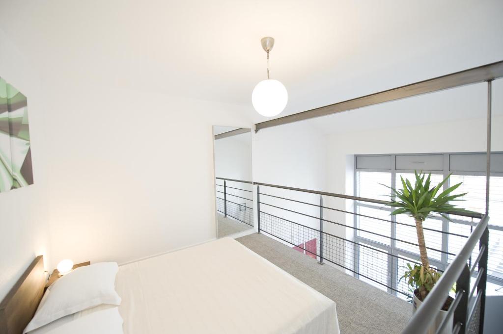 A bed or beds in a room at Hôtel des Capucins