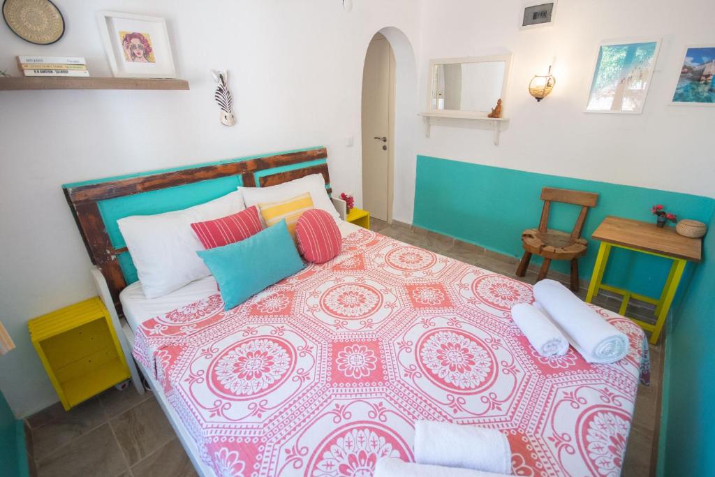 a bedroom with a large bed with colorful pillows at Kuytu Bed & Breakfast in Kas