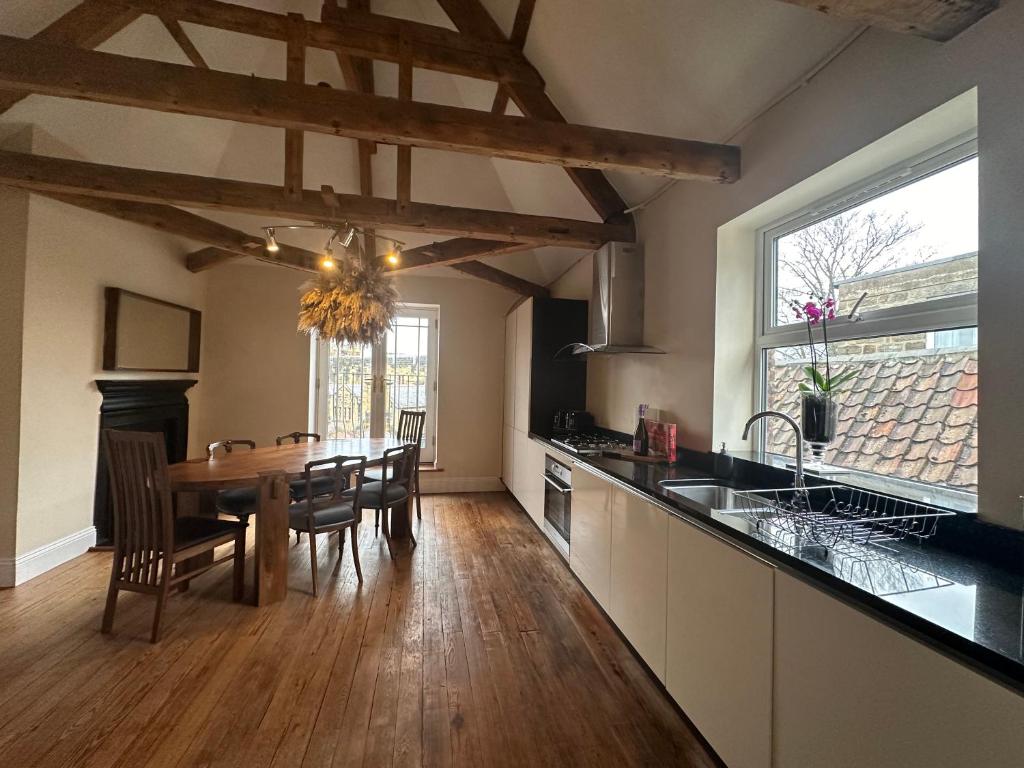a kitchen with a table and a dining room at Stunning 3 bedroom House with amazing Castle view in Alnwick