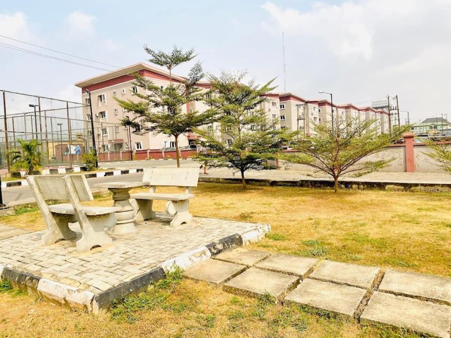 a picnic bench in a park with buildings in the background at Vim 2-BR-Apt With Fast Unlimited Internet & 24HRS Power in Lagos