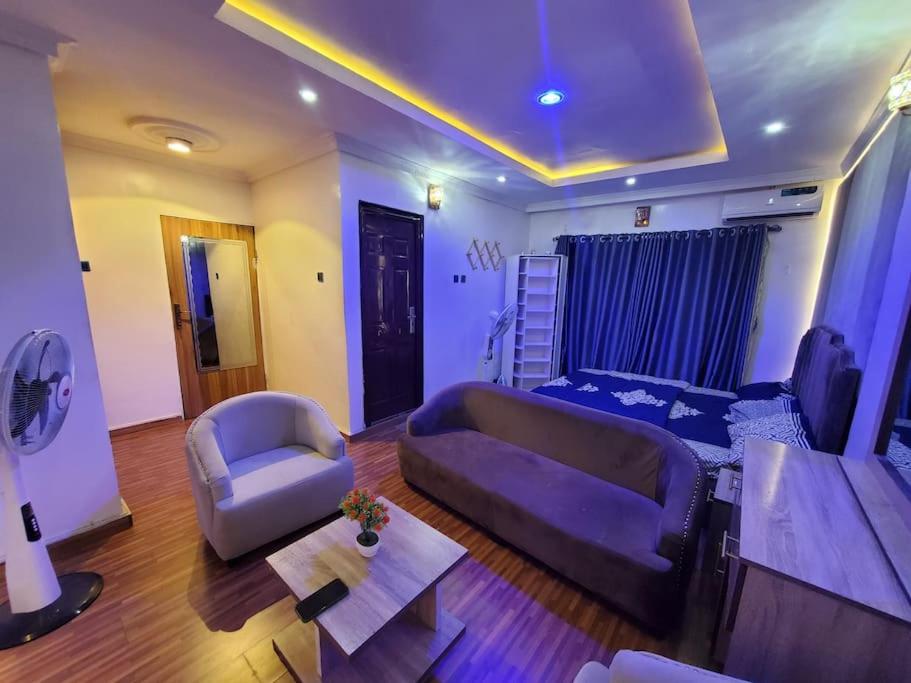 a living room with a purple couch and a chair at Vim 2-BR-Apt With Fast Unlimited Internet & 24HRS Power in Lagos