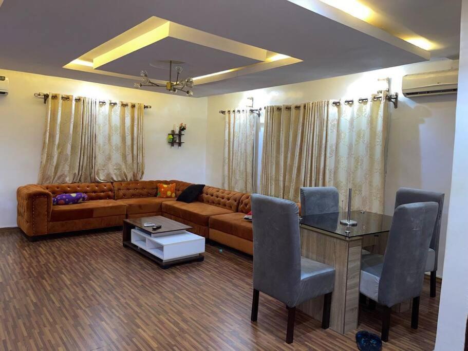 a living room with a couch and a table at Vim 2-BR-Apt With Fast Unlimited Internet & 24HRS Power in Lagos
