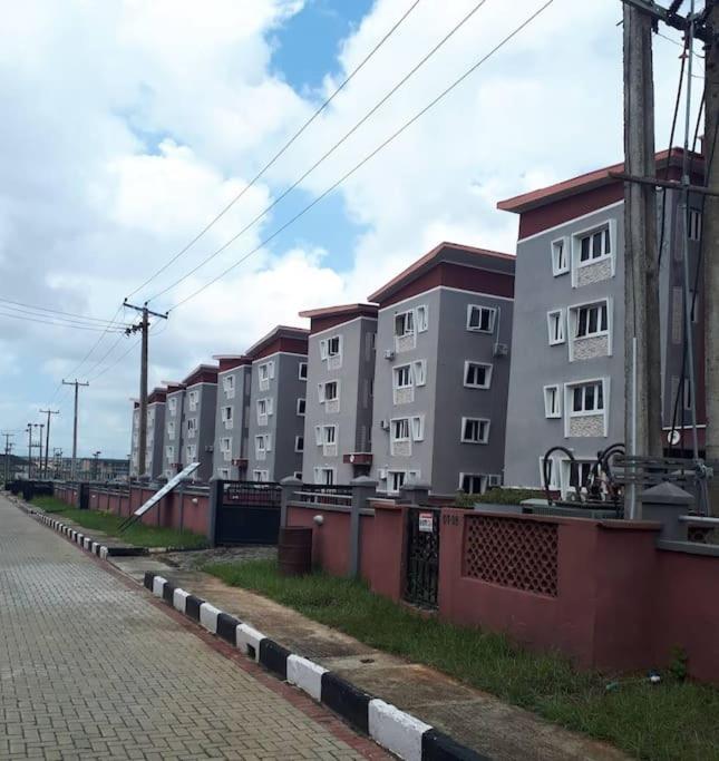a row of apartment buildings on the side of a street at Vim 2-BR-Apt With Fast Unlimited Internet & 24HRS Power in Lagos