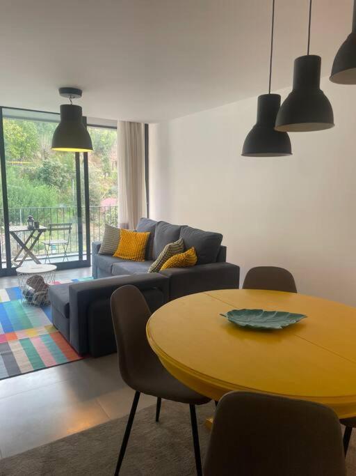 a living room with a table and a couch at Retiro das Andorinhas - Gerês in Geres
