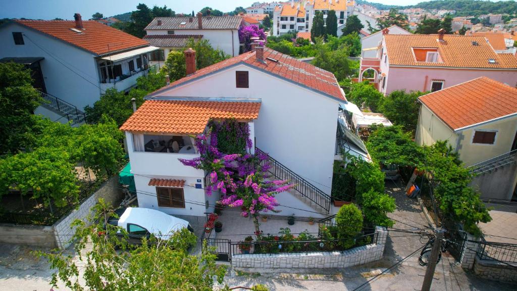 an aerial view of a white house with purple flowers at Apartmani Helena in Mali Lošinj