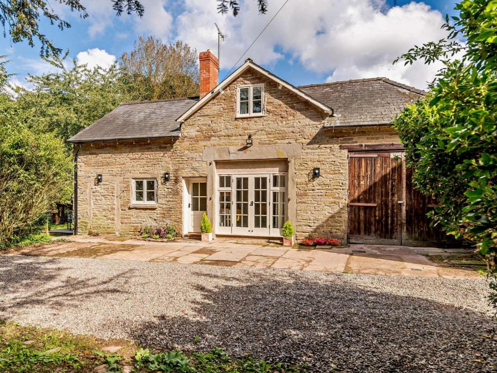 a stone house with a garage and a driveway at 3 Bed in Leominster 93304 in Bodenham